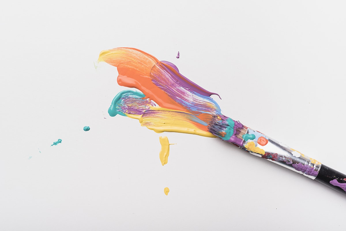 سب المقدسات- A vibrant paint brush bringing life to a blank canvas.