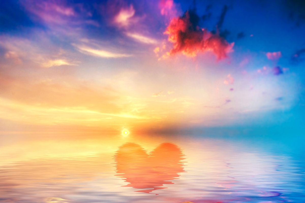 A heart reflects serenity in the water at sunset.